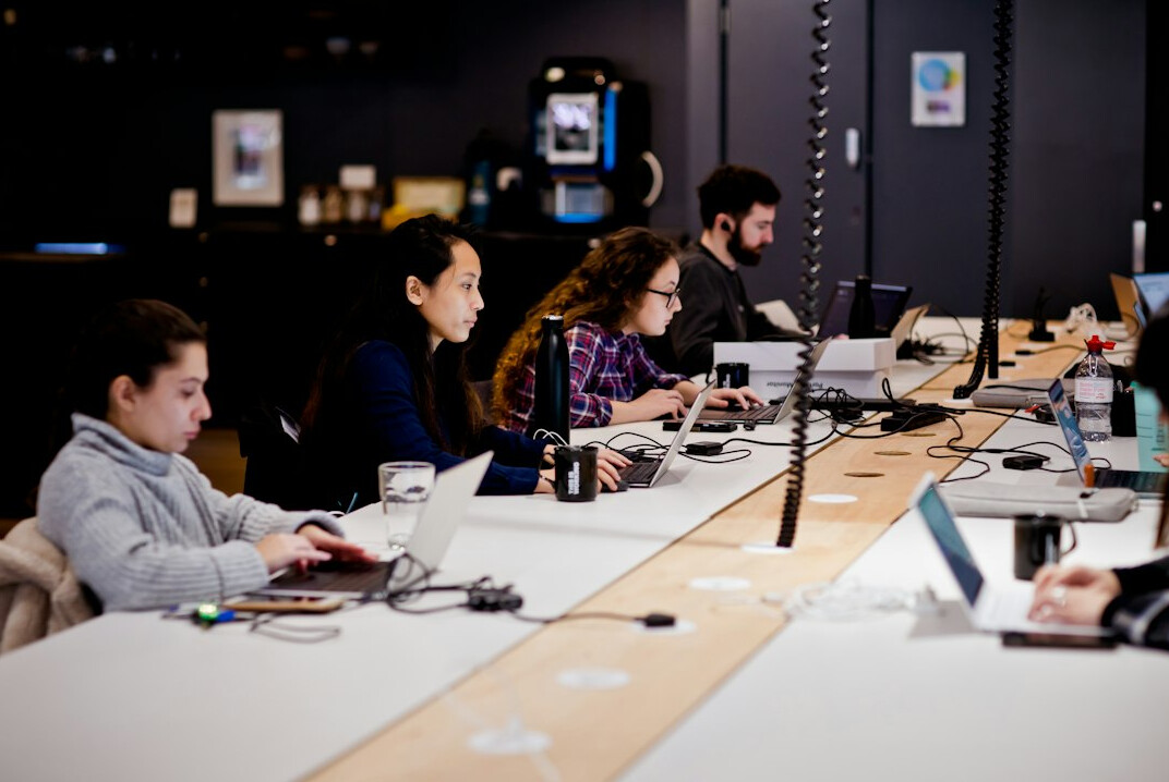 diverse group of students in coding workshop