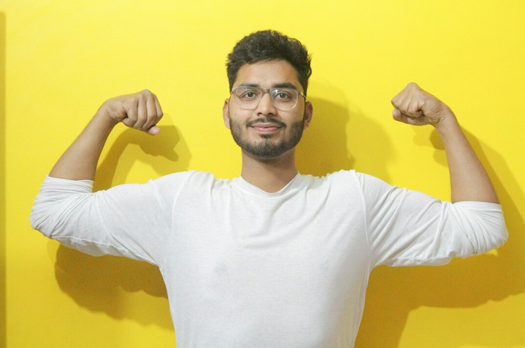 Studio portrait of an Indian Malaysian man programming mentor with glasses