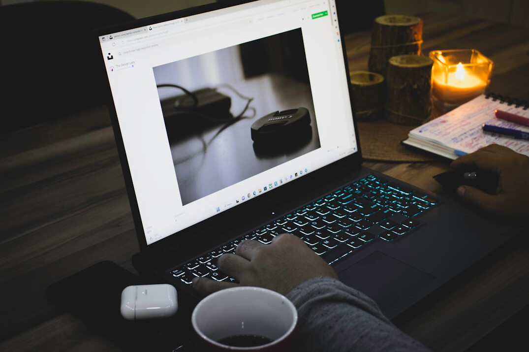 person coding on laptop