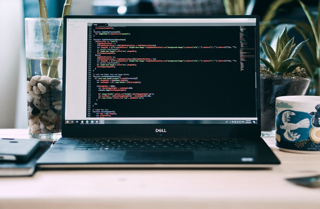 programmer at desk with laptop